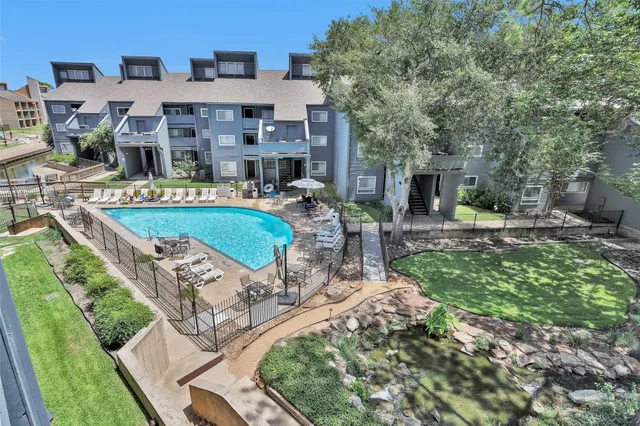 a aerial view of a house with garden and patio