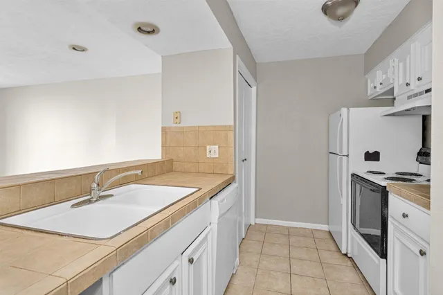 a kitchen with a sink stove and refrigerator