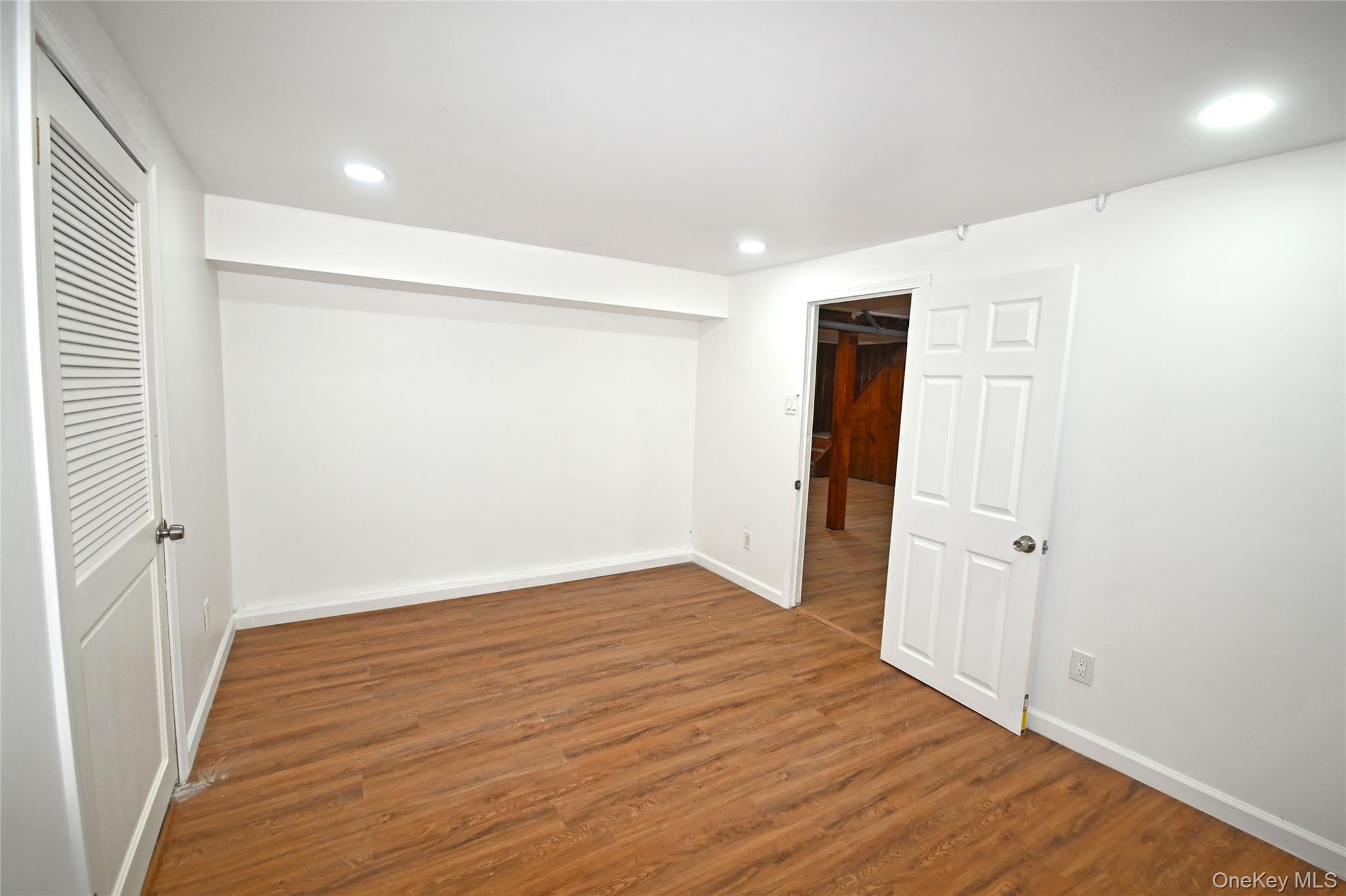 112-13 178th Street Queens, NY 11433 - Photo 15 of 28 Below grade area featuring wood finished floors and recessed lighting