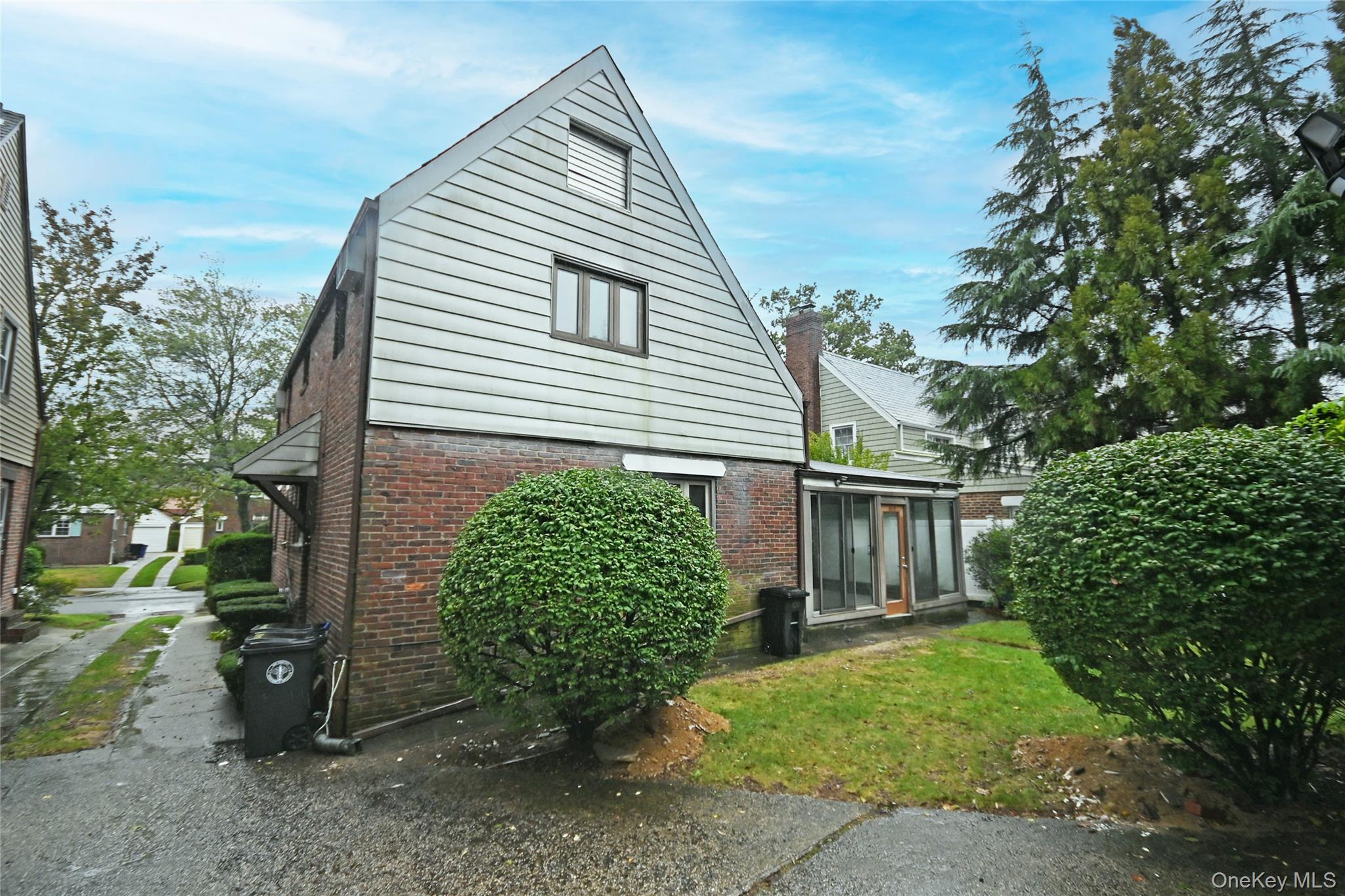 112-13 178th Street Queens, NY 11433 - Photo 26 of 28 View of property exterior featuring brick siding and a yard