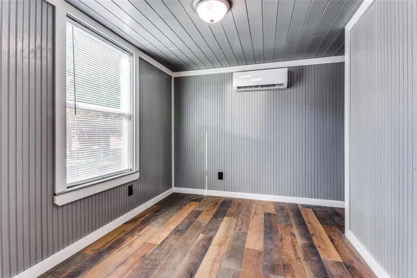 a view of a room with wooden floor and windows