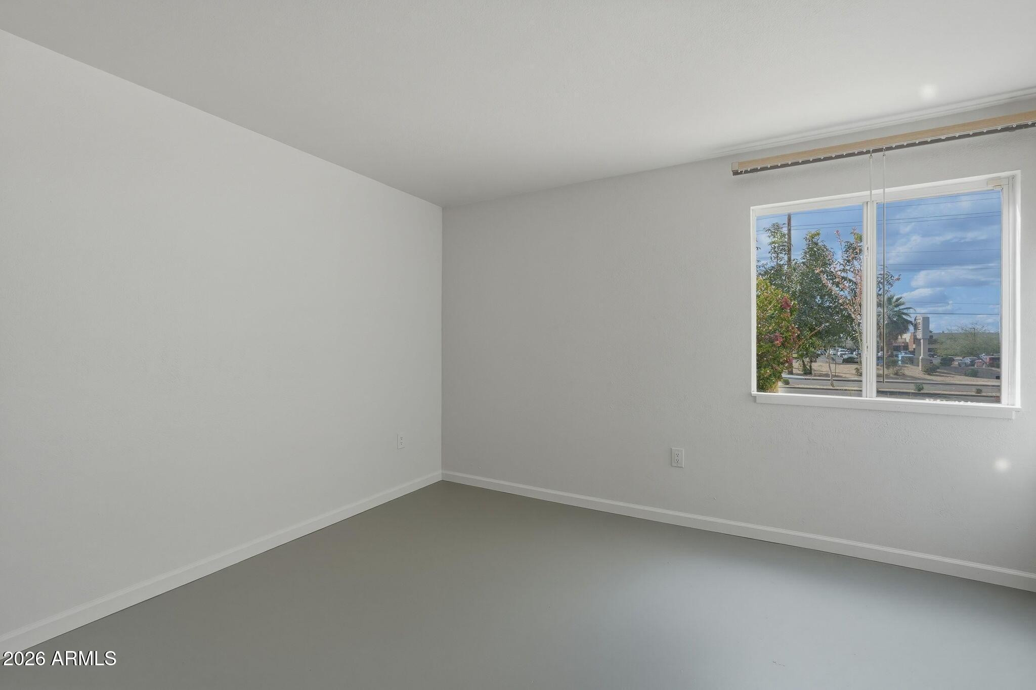 8055 East Thomas Road, Unit B107 Scottsdale, AZ 85251 - Photo 14 of 28 an empty room with a window
