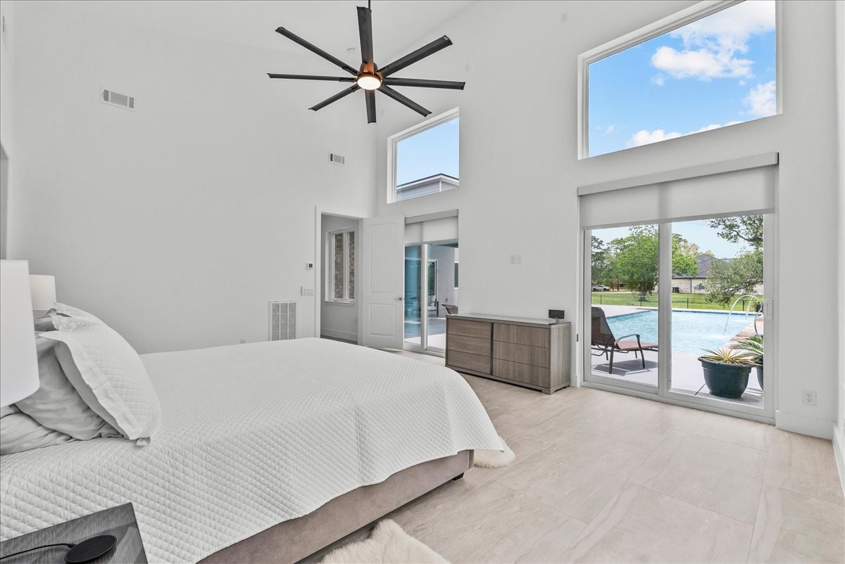7627 Scott Avenue Manvel, TX 77578 - Photo 24 of 50 The 20 x16 primary suite features oversized sliding glass doors and clerestory windows that offer breathtaking views.
