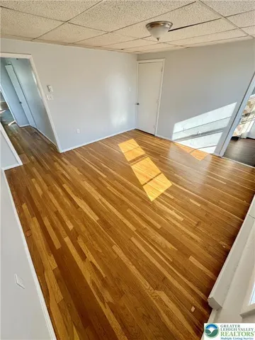 a view of a room with wooden floor