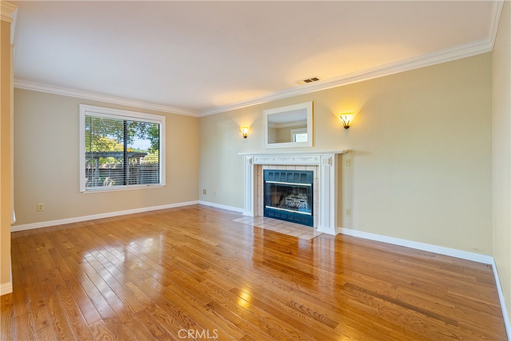 6815 Santa Lucia Road, Unit 5 Atascadero, CA 93422 - Photo 11 of 44 Cozy living room enjoys a wood burning stove, sconce lights and large windows that usher light in.
