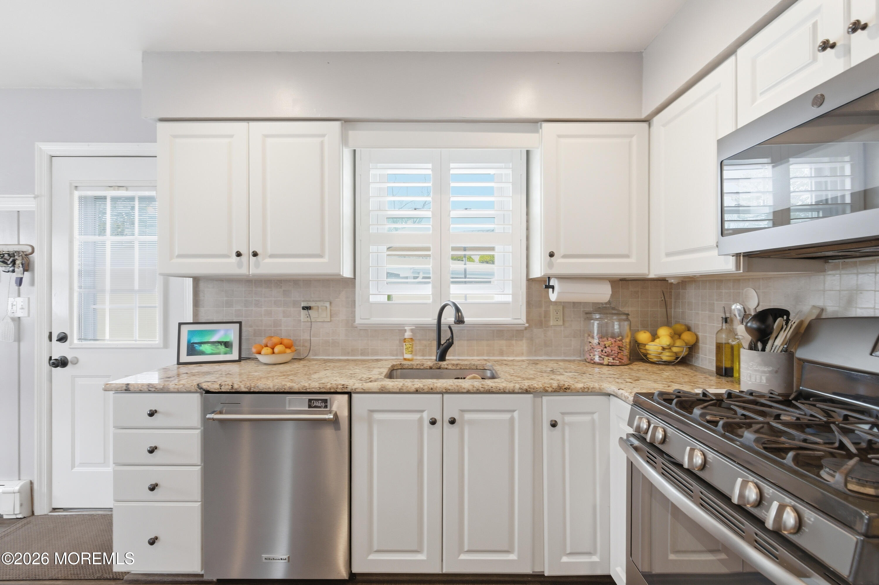 1155 Lockhart Lane Point Pleasant, NJ 08742 - Photo 16 of 33 a kitchen with granite countertop a sink a stove and cabinets