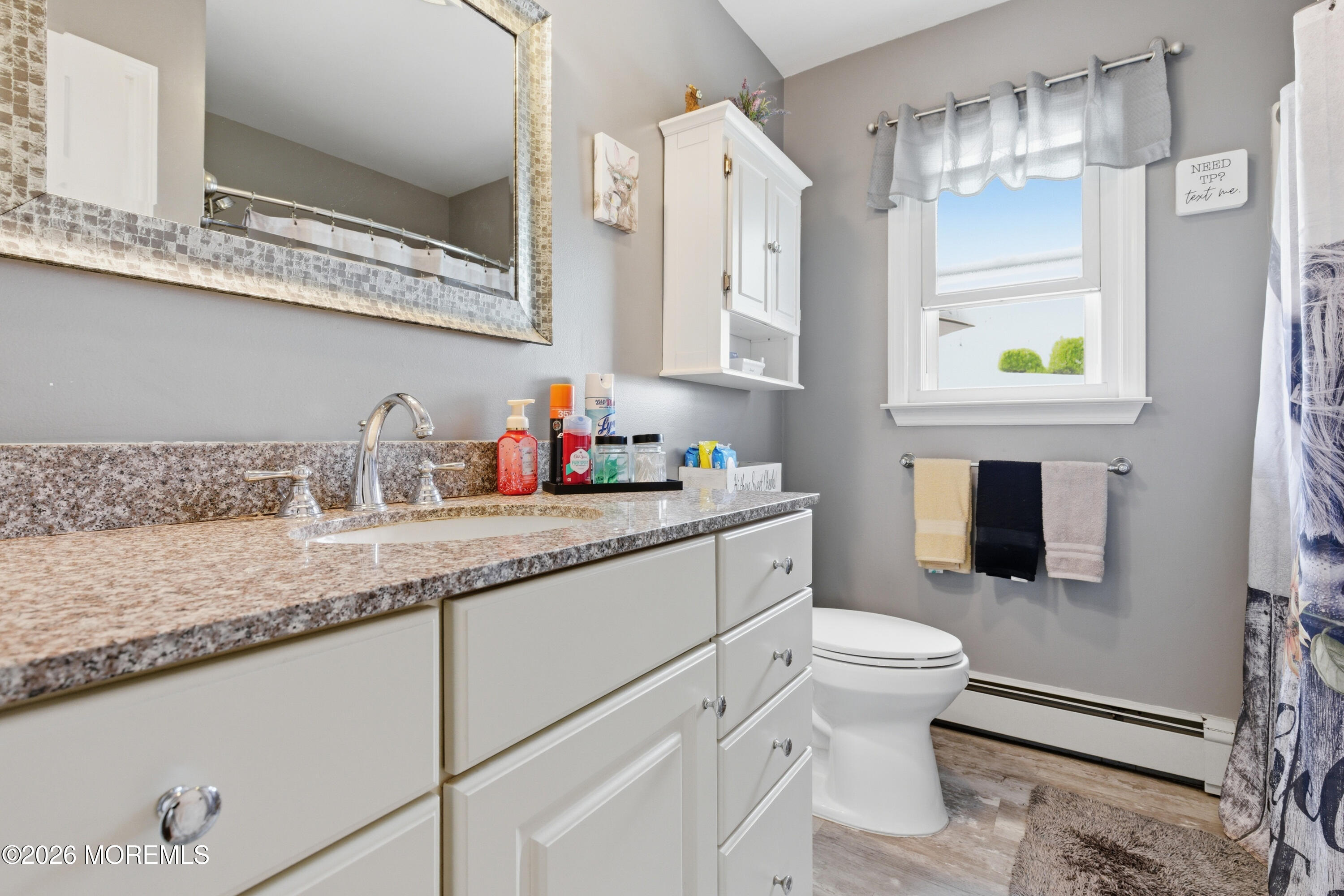 1155 Lockhart Lane Point Pleasant, NJ 08742 - Photo 19 of 33 a bathroom with a granite countertop sink a toilet and mirror