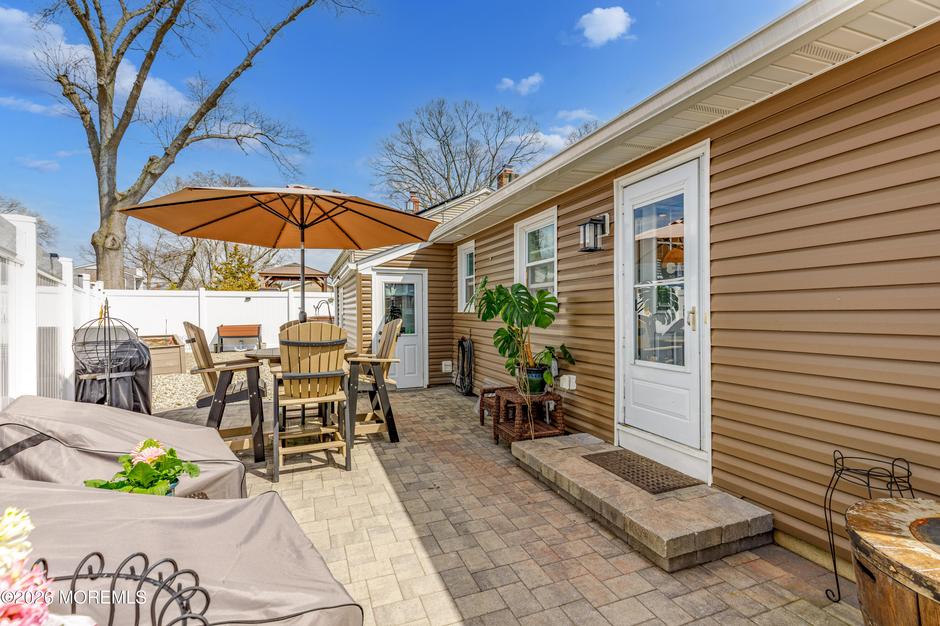 1155 Lockhart Lane Point Pleasant, NJ 08742 - Photo 24 of 33 a view of a patio with a table and chairs under an umbrella
