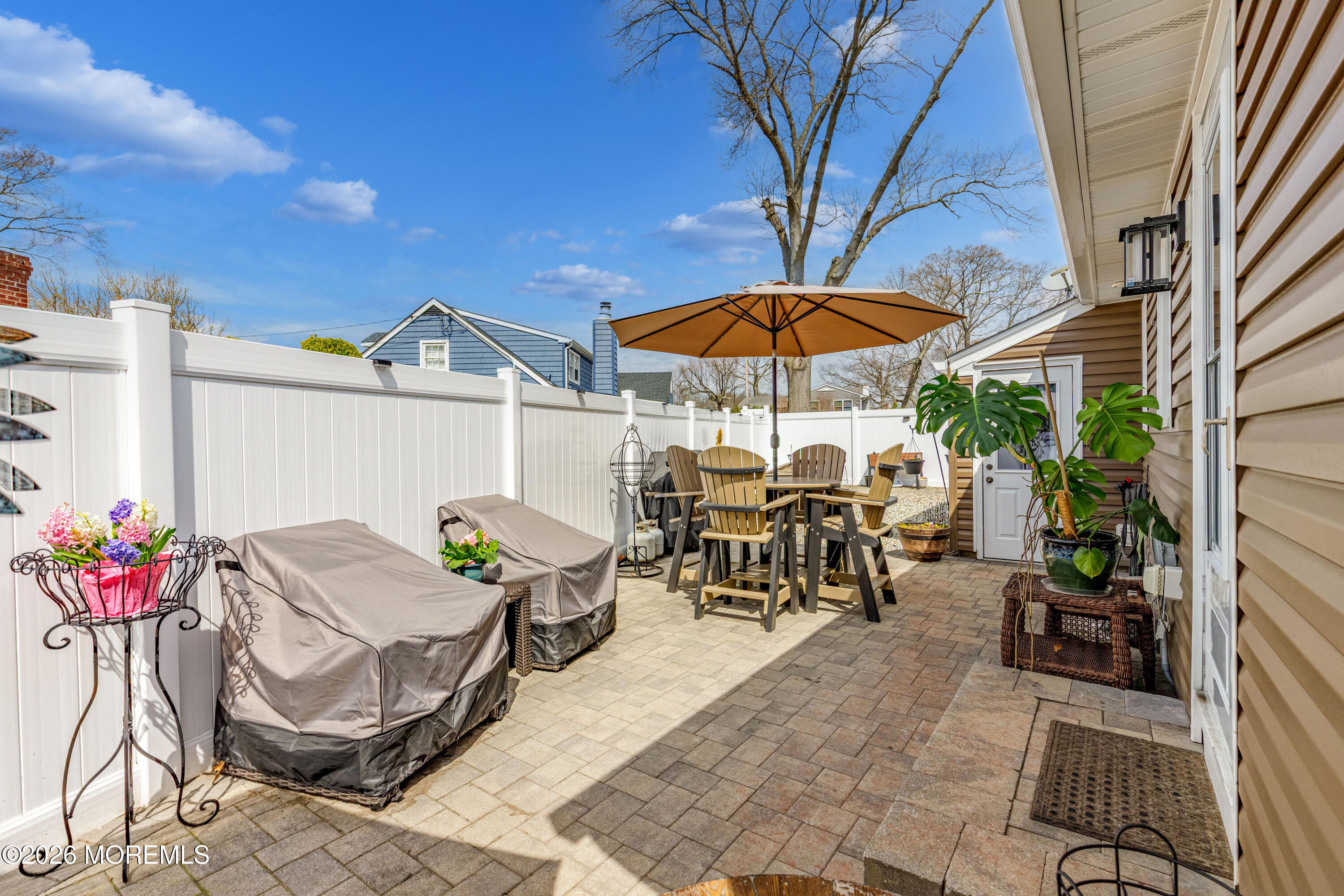 1155 Lockhart Lane Point Pleasant, NJ 08742 - Photo 25 of 33 a view of a patio with chairs and table under an umbrella