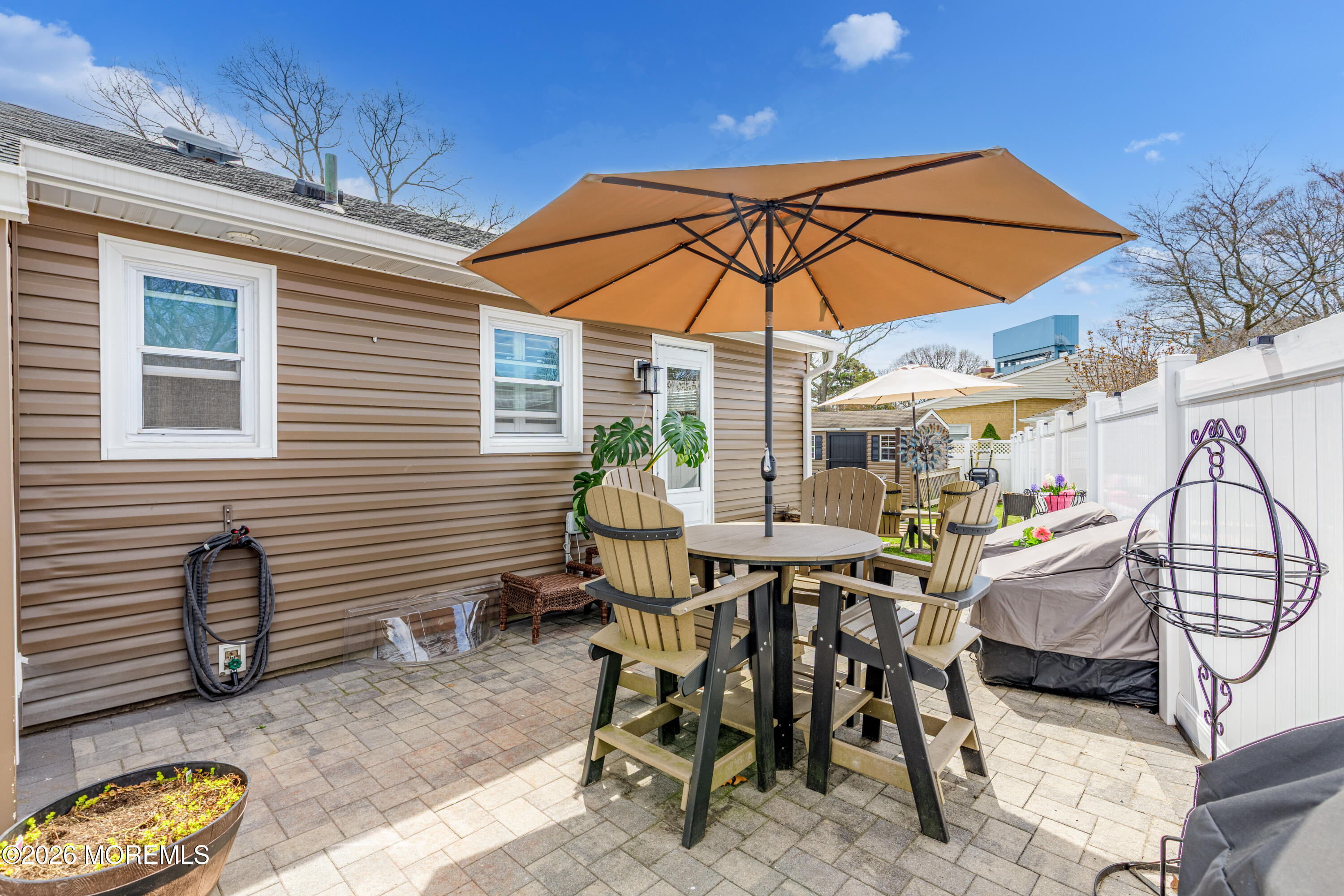 1155 Lockhart Lane Point Pleasant, NJ 08742 - Photo 26 of 33 a view of a patio with a table and chairs under an umbrella