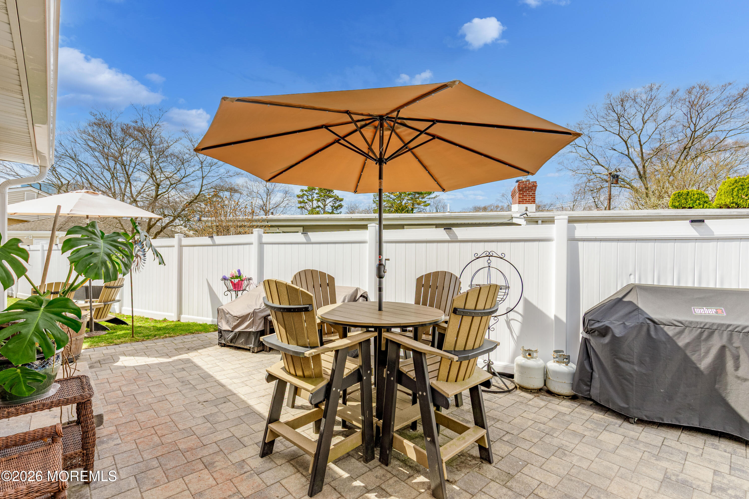 1155 Lockhart Lane Point Pleasant, NJ 08742 - Photo 27 of 33 a view of patio with table and chairs under an umbrella