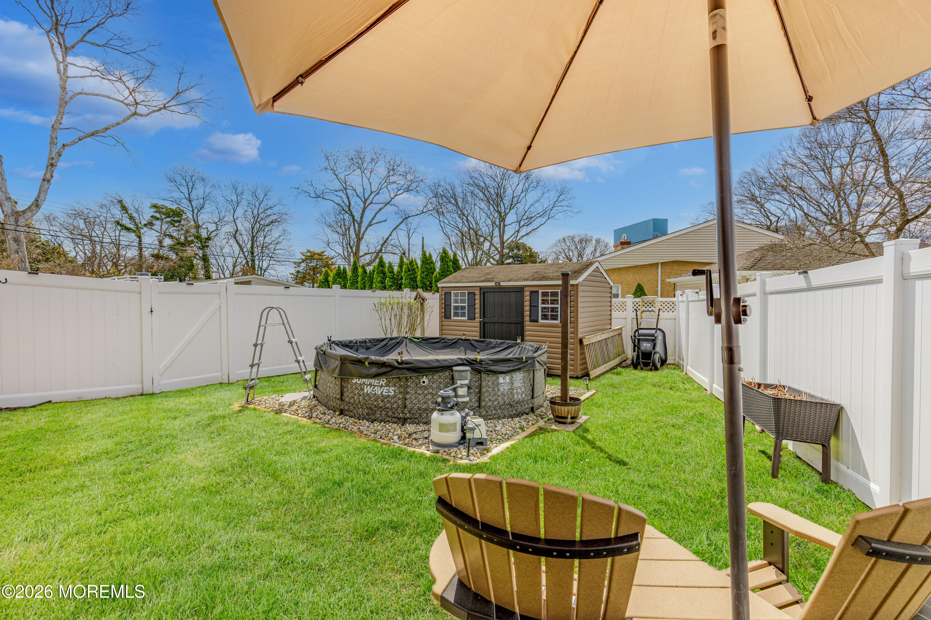 1155 Lockhart Lane Point Pleasant, NJ 08742 - Photo 28 of 33 a view of a backyard with table and chairs potted plants