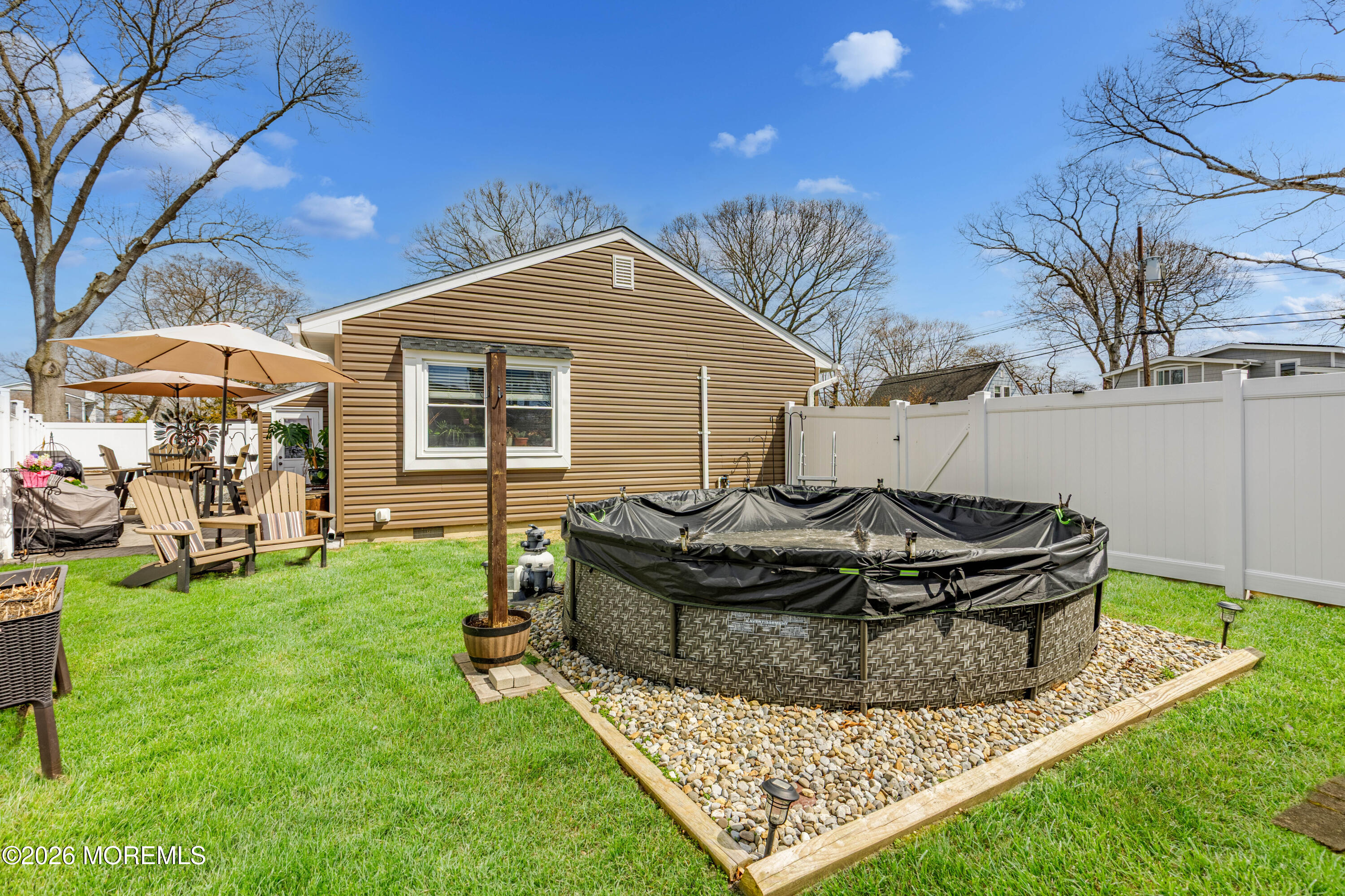 1155 Lockhart Lane Point Pleasant, NJ 08742 - Photo 33 of 33 a view of a backyard with table and chairs and a fire pit
