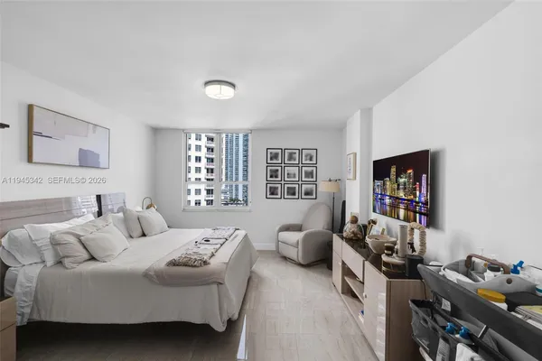 a bedroom with a bed and a flat screen tv