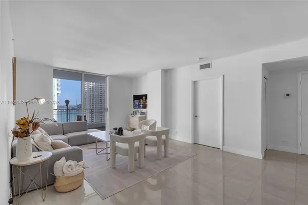 a living room with furniture and a large window