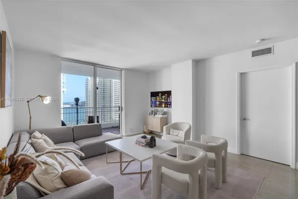 a living room with furniture and large window