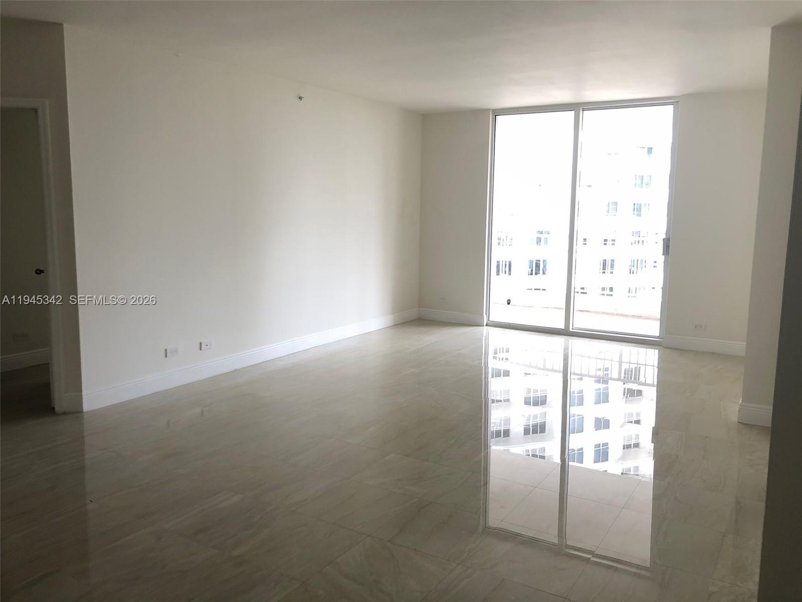 701 Brickell Key Boulevard, Unit 1606 Miami, FL 33131 - Photo 4 of 8 a view of an empty room with a window