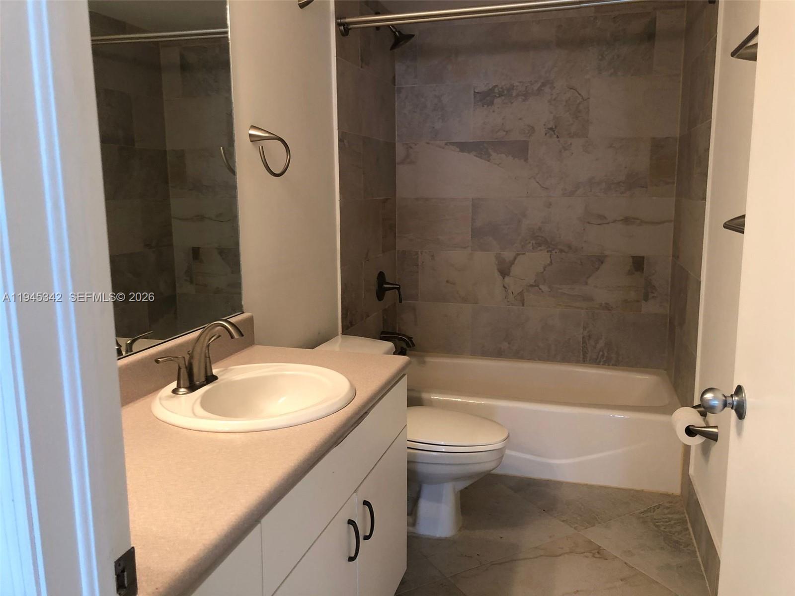 701 Brickell Key Boulevard, Unit 1606 Miami, FL 33131 - Photo 6 of 8 a bathroom with a sink a toilet and shower
