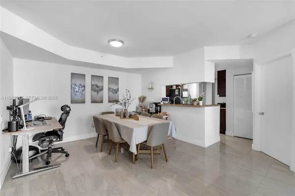 a kitchen with stainless steel appliances granite countertop a refrigerator a sink a stove and dishwasher