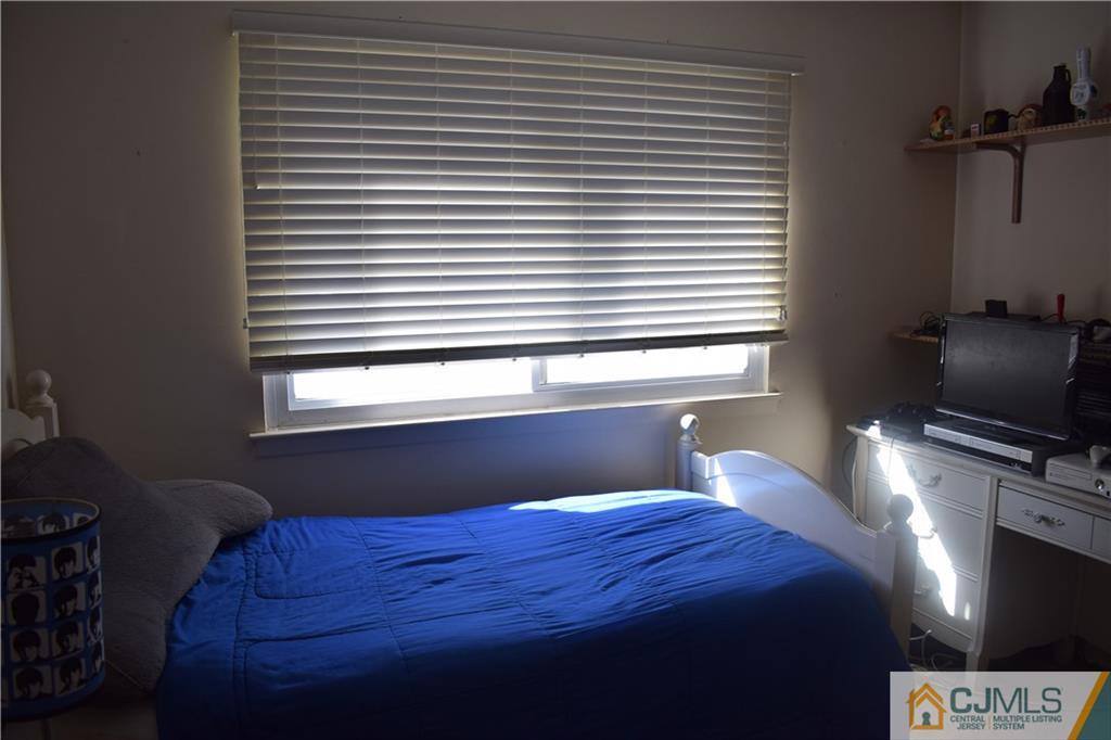 10 Harper Road Monmouth Junction, NJ 08852 - Photo 11 of 24 a bedroom with a bed and a window