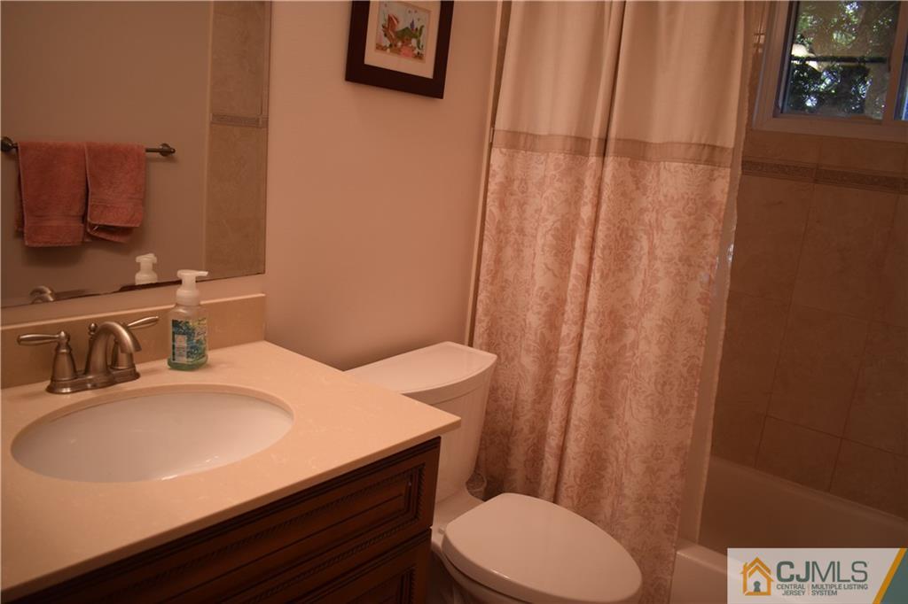 10 Harper Road Monmouth Junction, NJ 08852 - Photo 14 of 24 a bathroom with a sink a toilet and shower curtain