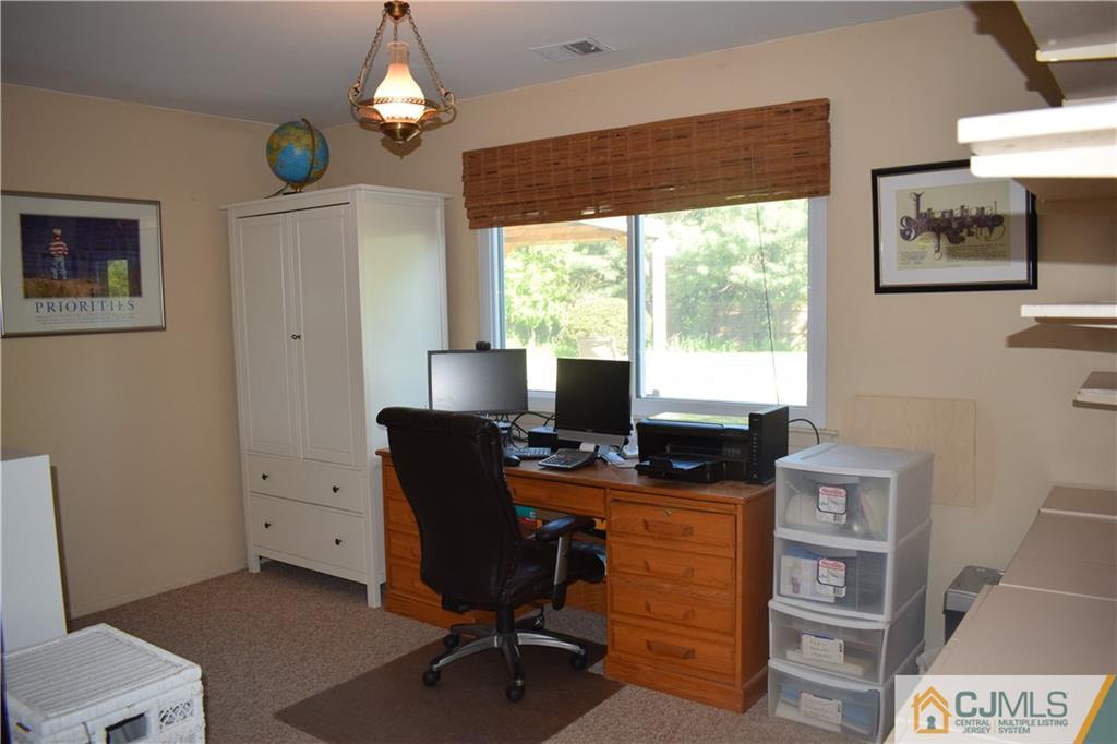 10 Harper Road Monmouth Junction, NJ 08852 - Photo 18 of 24 a view of a workspace with furniture and a window