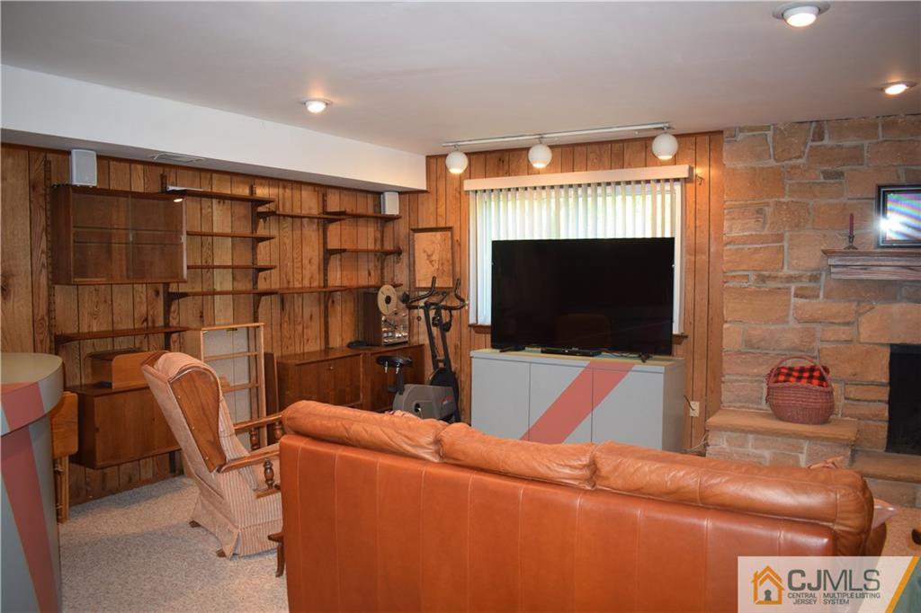 10 Harper Road Monmouth Junction, NJ 08852 - Photo 19 of 24 a living room with furniture and a flat screen tv