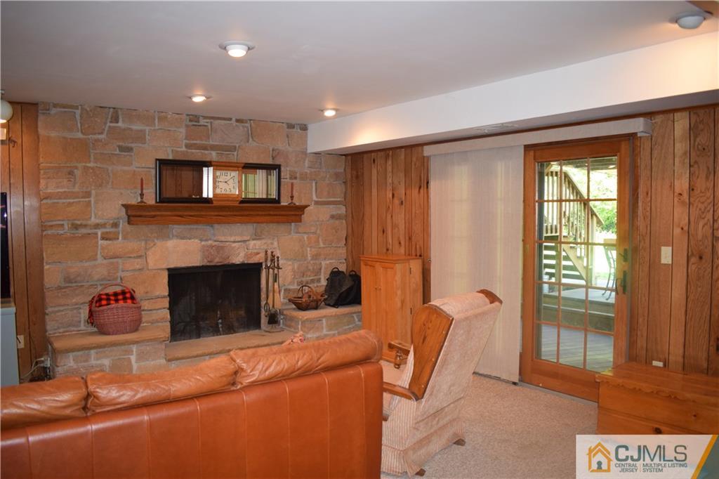 10 Harper Road Monmouth Junction, NJ 08852 - Photo 20 of 24 a living room with furniture a fireplace and a flat screen tv
