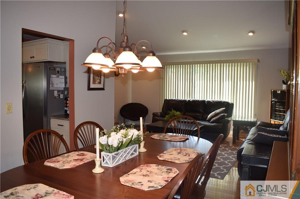 10 Harper Road Monmouth Junction, NJ 08852 - Photo 6 of 24 a dining room with furniture a chandelier and a mirror