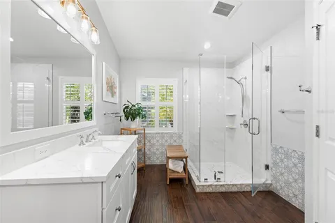 a bathroom with a sink a toilet and shower