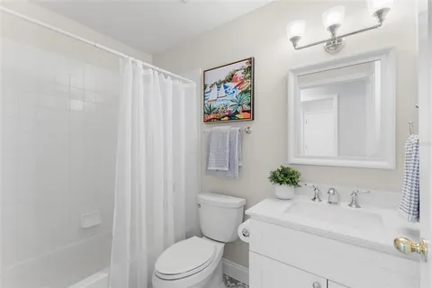 a bathroom with a sink mirror vanity and toilet