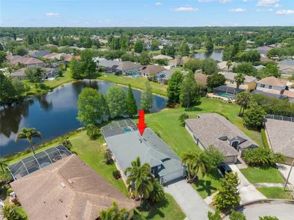 an aerial view of residential houses with outdoor space and lake view
