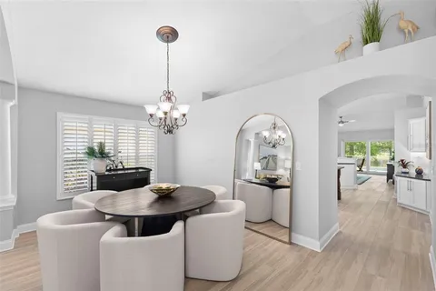 a view of a dining room with furniture wooden floor and chandelier