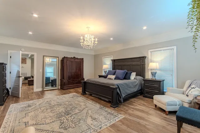 a spacious bedroom with a bed and a television in it