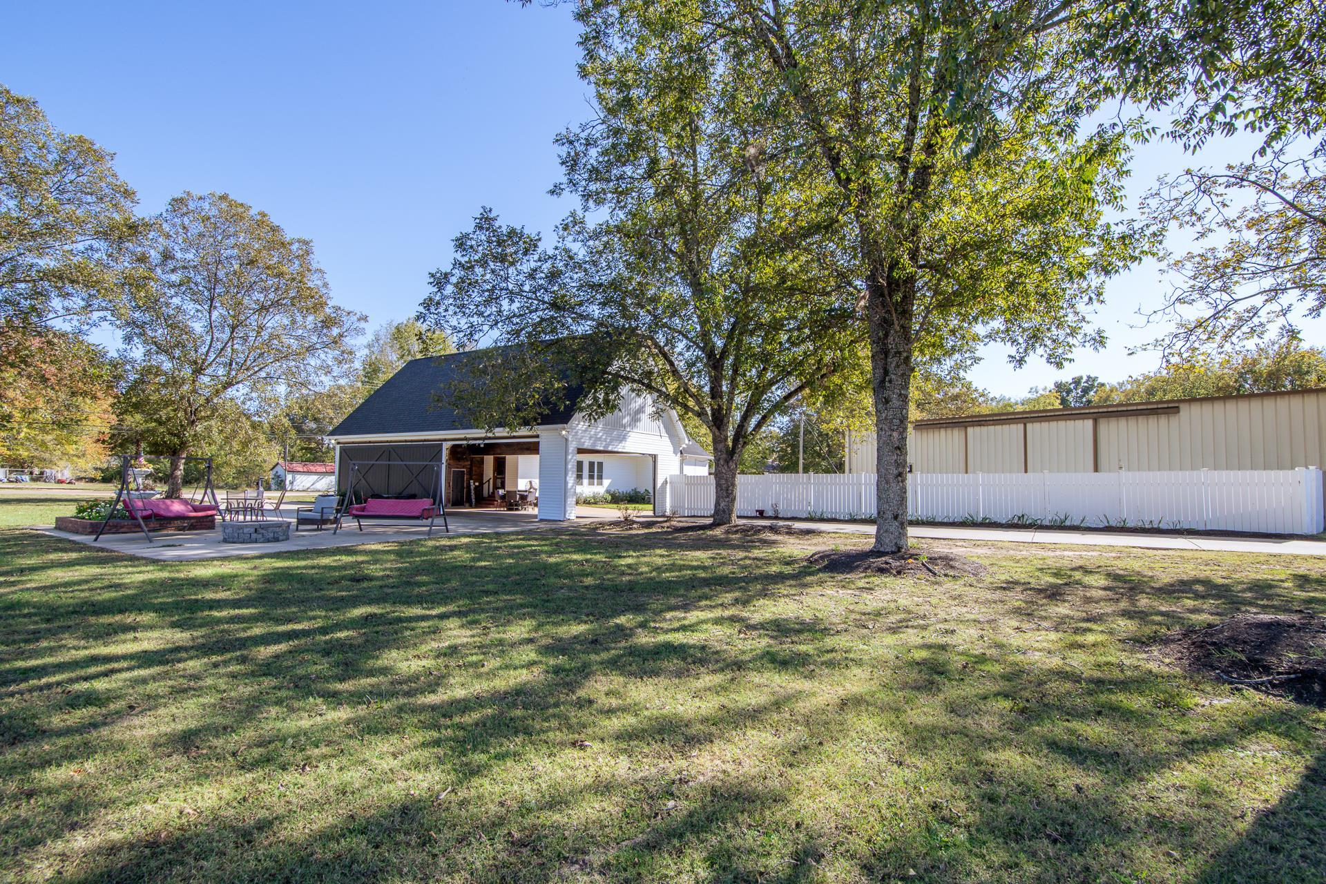 635 Patterson Road Savannah, TN 38372 - Photo 26 of 33 a big white house with a yard and large trees