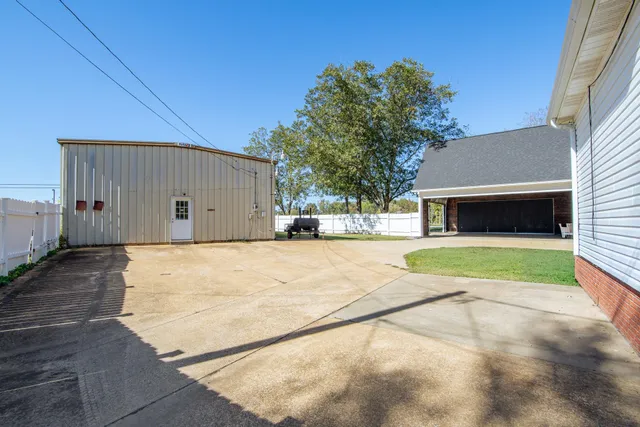 a view of a house with backyard and sitting area