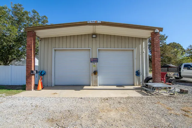 a view of garage with yard