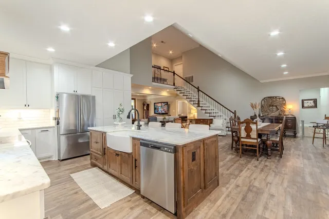a kitchen with a sink appliances and cabinets