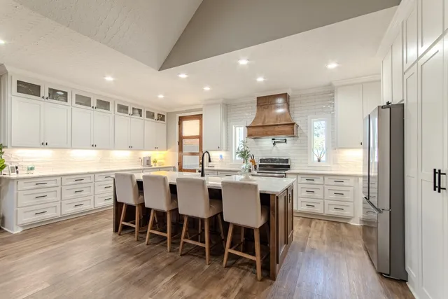 a kitchen with granite countertop a sink stove and cabinets