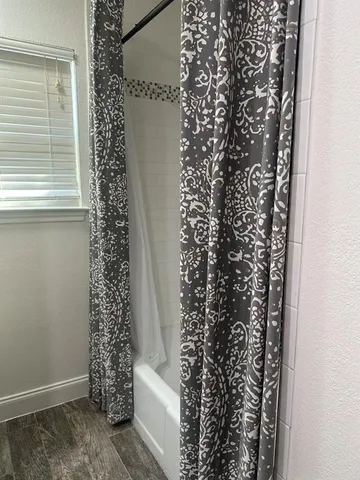 a bathroom with a window and a shower