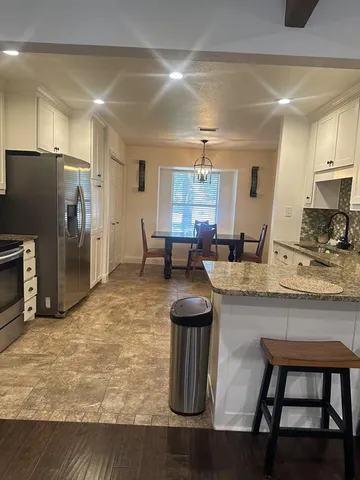 a kitchen with counter top space cabinets and stainless steel appliances