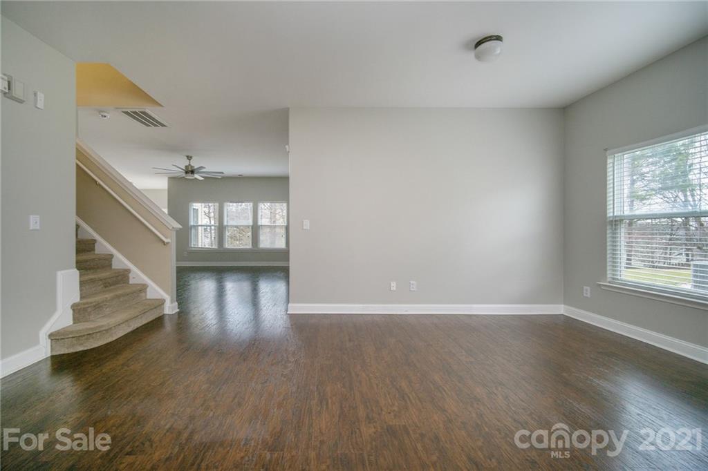 382 Primrose Walk Fort Mill, SC 29715 - Photo 3 of 20 a view of an empty room with wooden floor and a window