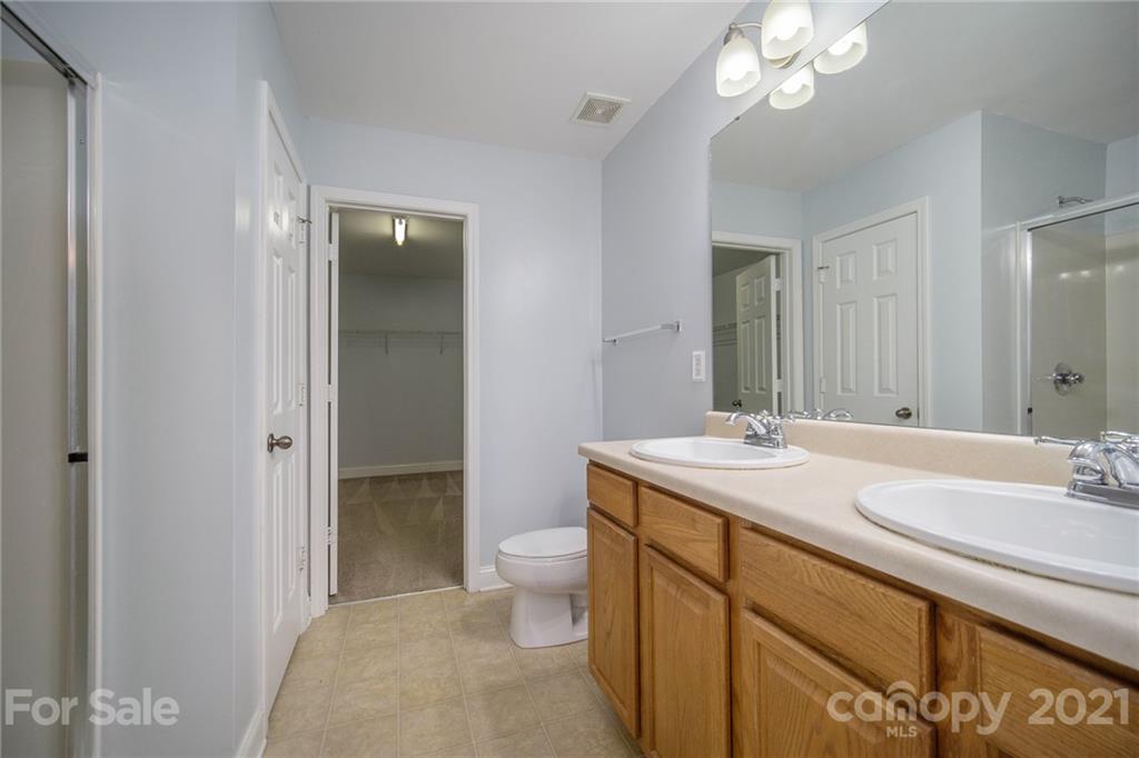 382 Primrose Walk Fort Mill, SC 29715 - Photo 4 of 20 a bathroom with a sink a toilet and shower