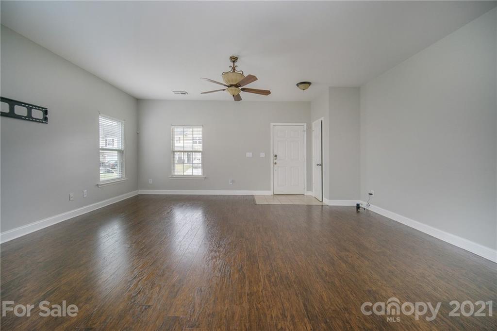 382 Primrose Walk Fort Mill, SC 29715 - Photo 6 of 20 an empty room with wooden floor and windows