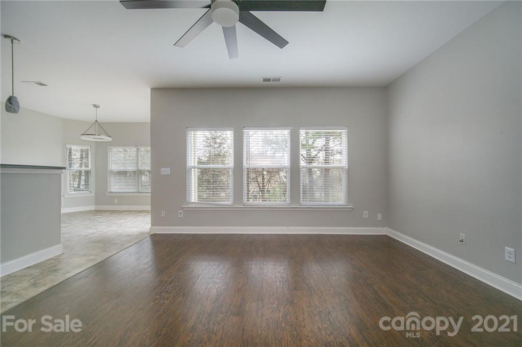 382 Primrose Walk Fort Mill, SC 29715 - Photo 8 of 20 a view of an empty room with wooden floor and a window