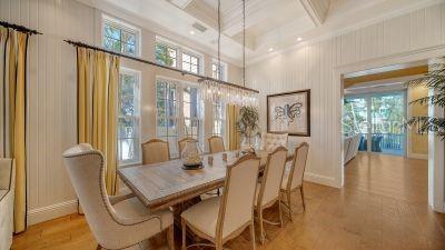 5309 Hidden Harbor Road Sarasota, FL 34242 - Photo 14 of 88 a view of a dining room with furniture wooden floor and a chandelier