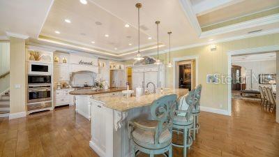 5309 Hidden Harbor Road Sarasota, FL 34242 - Photo 21 of 88 a kitchen with stainless steel appliances granite countertop a stove and a refrigerator