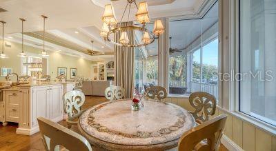 5309 Hidden Harbor Road Sarasota, FL 34242 - Photo 29 of 88 a very nice looking dining room with a large window and chandelier