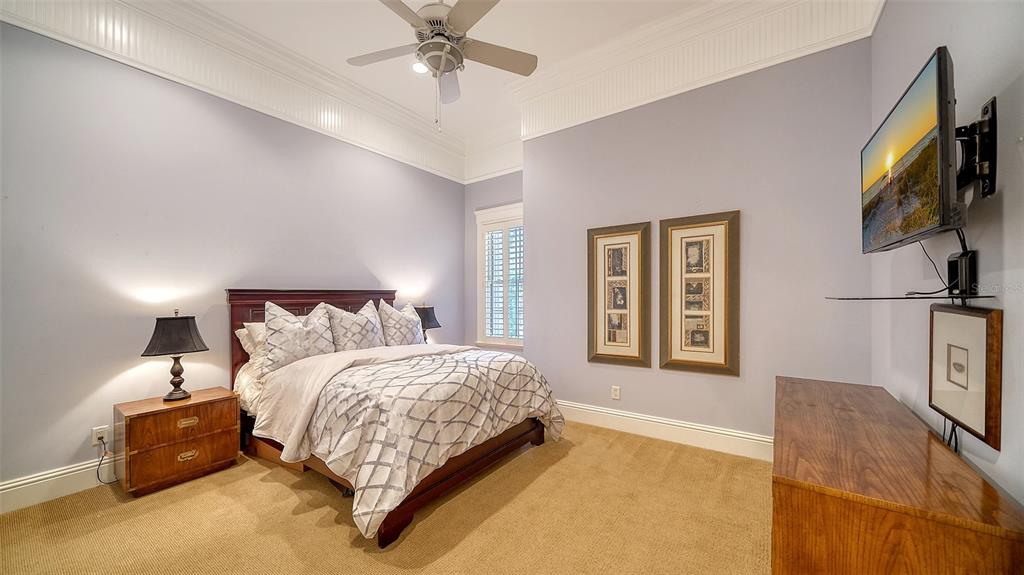 5309 Hidden Harbor Road Sarasota, FL 34242 - Photo 38 of 100 a bedroom with a large bed and a flat tv screen on dresser