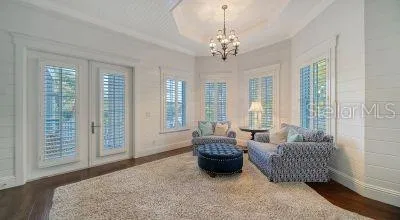 a bedroom with a bed a ceiling fan and a large window